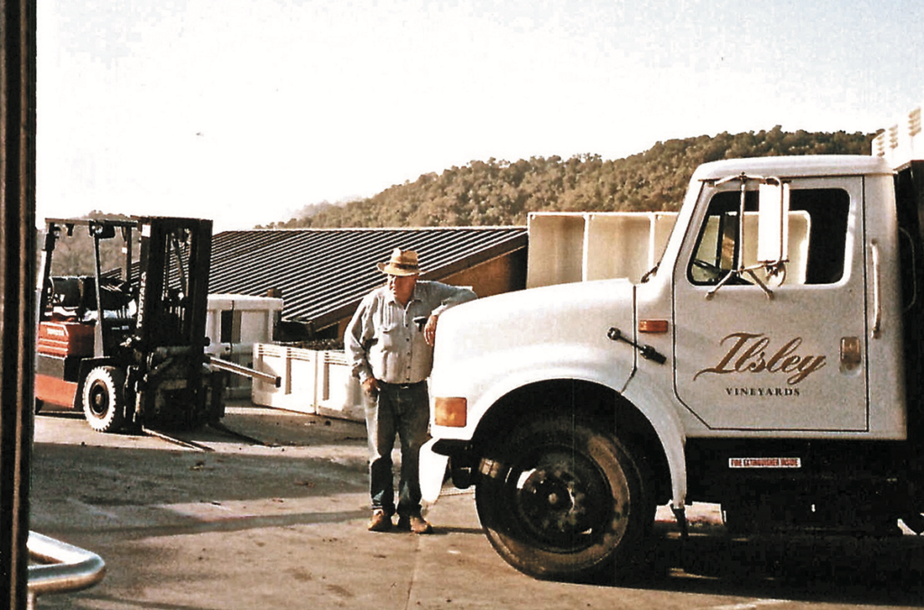 Ed with Ilsley Vineyards truck with boxes of grapes forklift in background